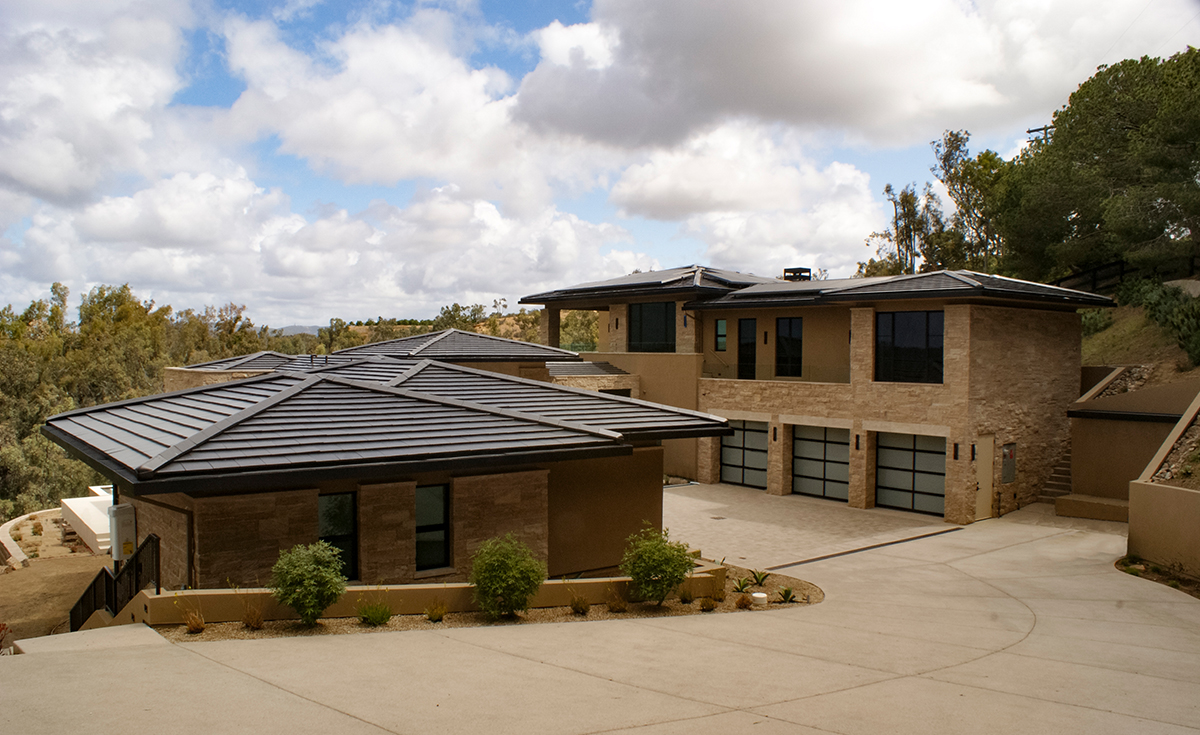 side view of modern style home with MF108 interlocking flat clay roof tile in C16 Matte Black color