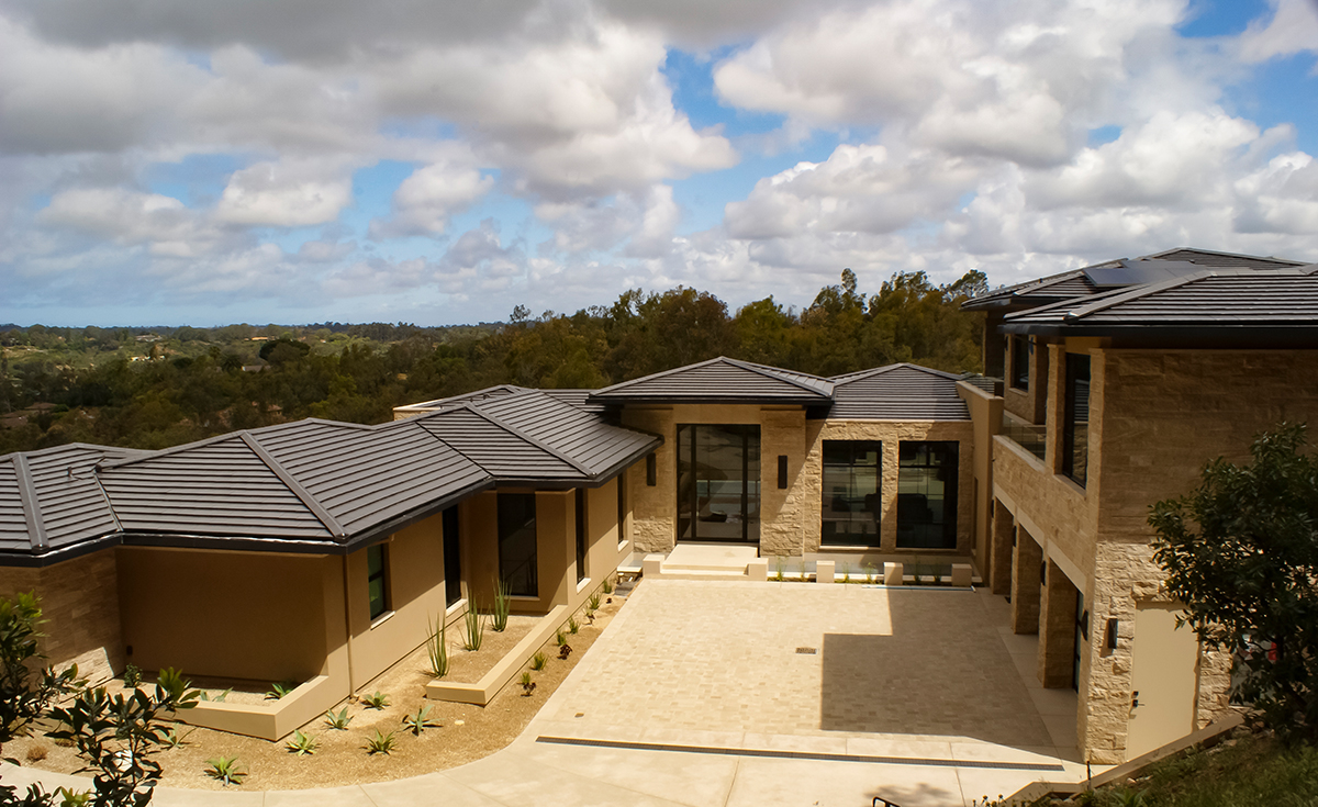 wide elevated view of modern style home with MF108 interlocking flat clay roof tile in C16 Matte Black color