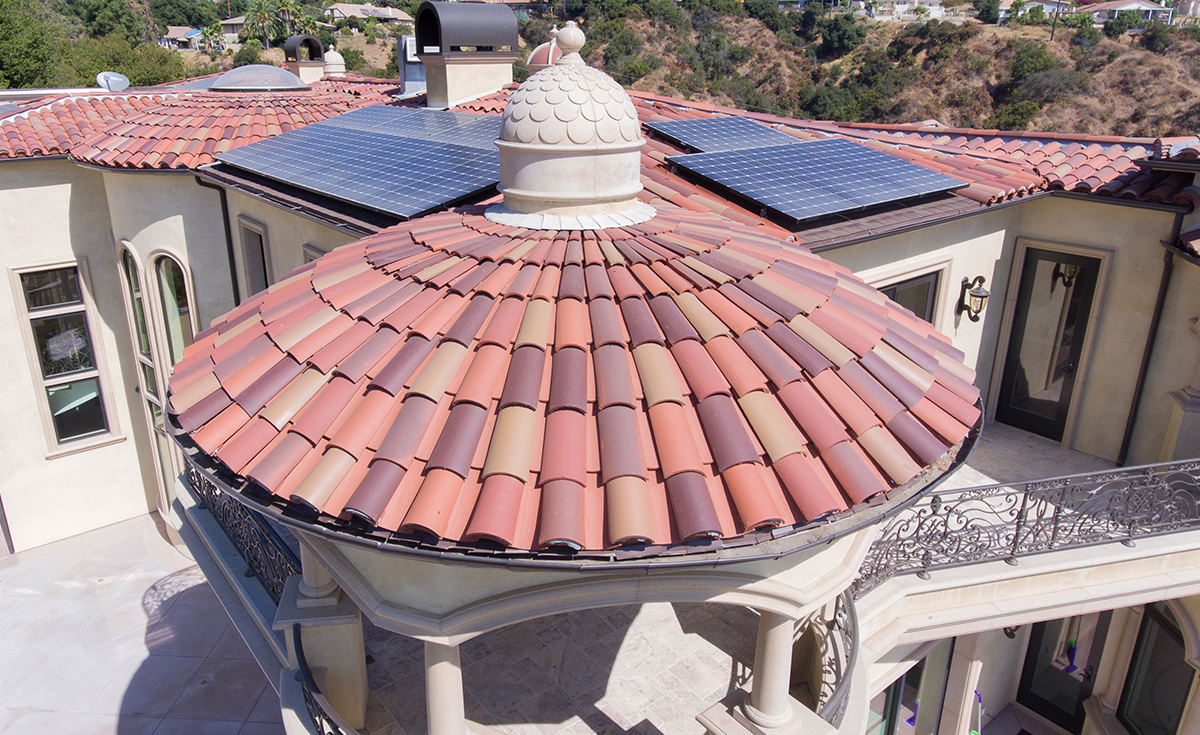 Close up of a dome roof installation on a custom mansion on a hilltop in Bradbury California featuring Classic Tapered two piece terra-cotta clay roof tile with turrets, domes, and dome awnings in custom color blend CB477.