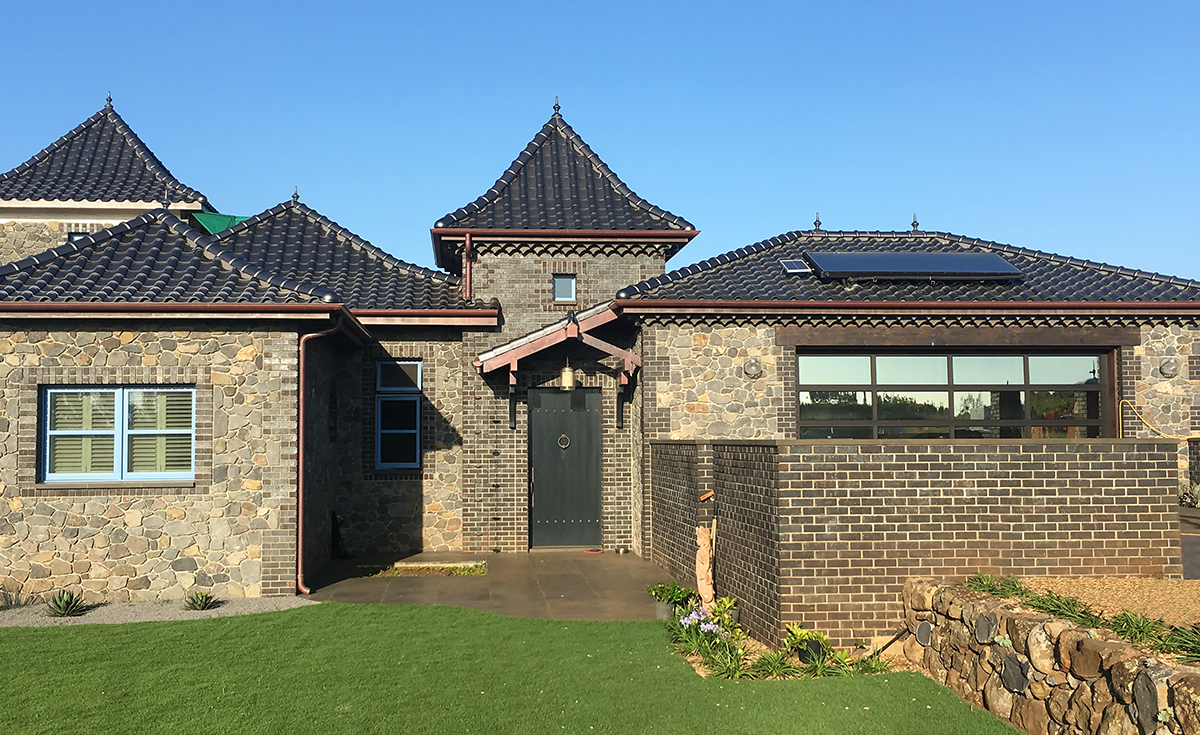 French Chateau inspired home with Improved S clay roof tile with genoise eave in C23 Metallic Silver Clay Roof Tile in Maui, HI