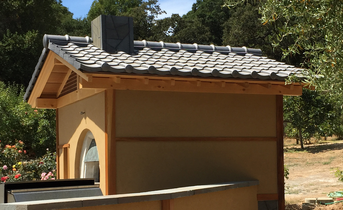 Detail of Oriental-Japanes clay roof tile in C09 Japanese Black on a backyard pizza oven in Northern California