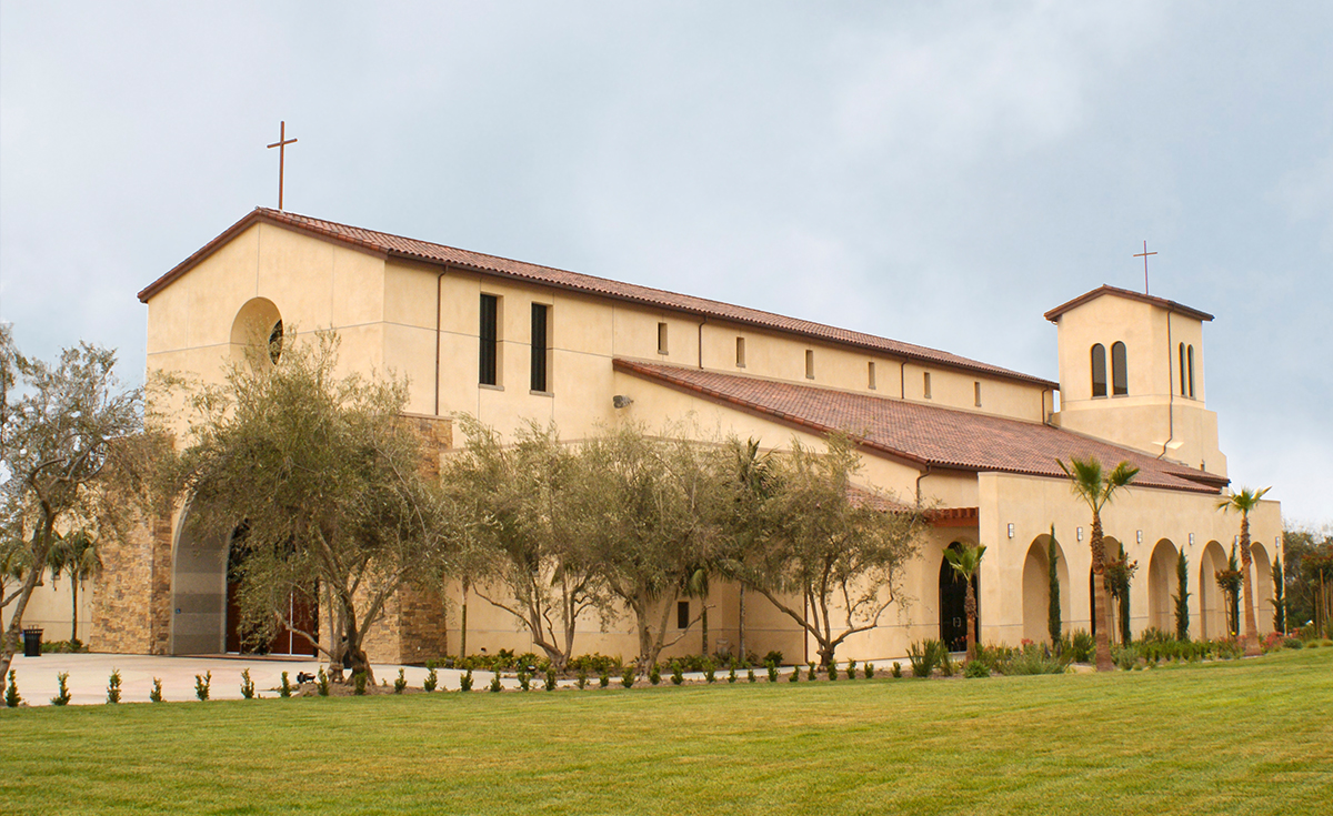 One Piece S Mission clay roof tile in B330-R Old Santa Barbara Blend with two piece eace line on Holy Trinity Catholic Church in Ladera Ranch, California