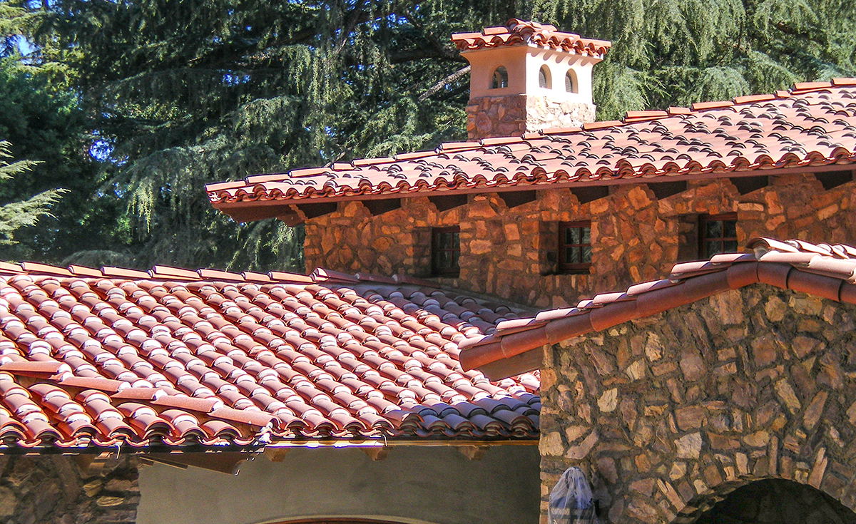 Detail of classic tapered mission clay roof two piece tile in 67% F72 Mahogany and 33% F45 tobacco with weepy mortar and field boosting on custom home in La Cañada Flintridge California