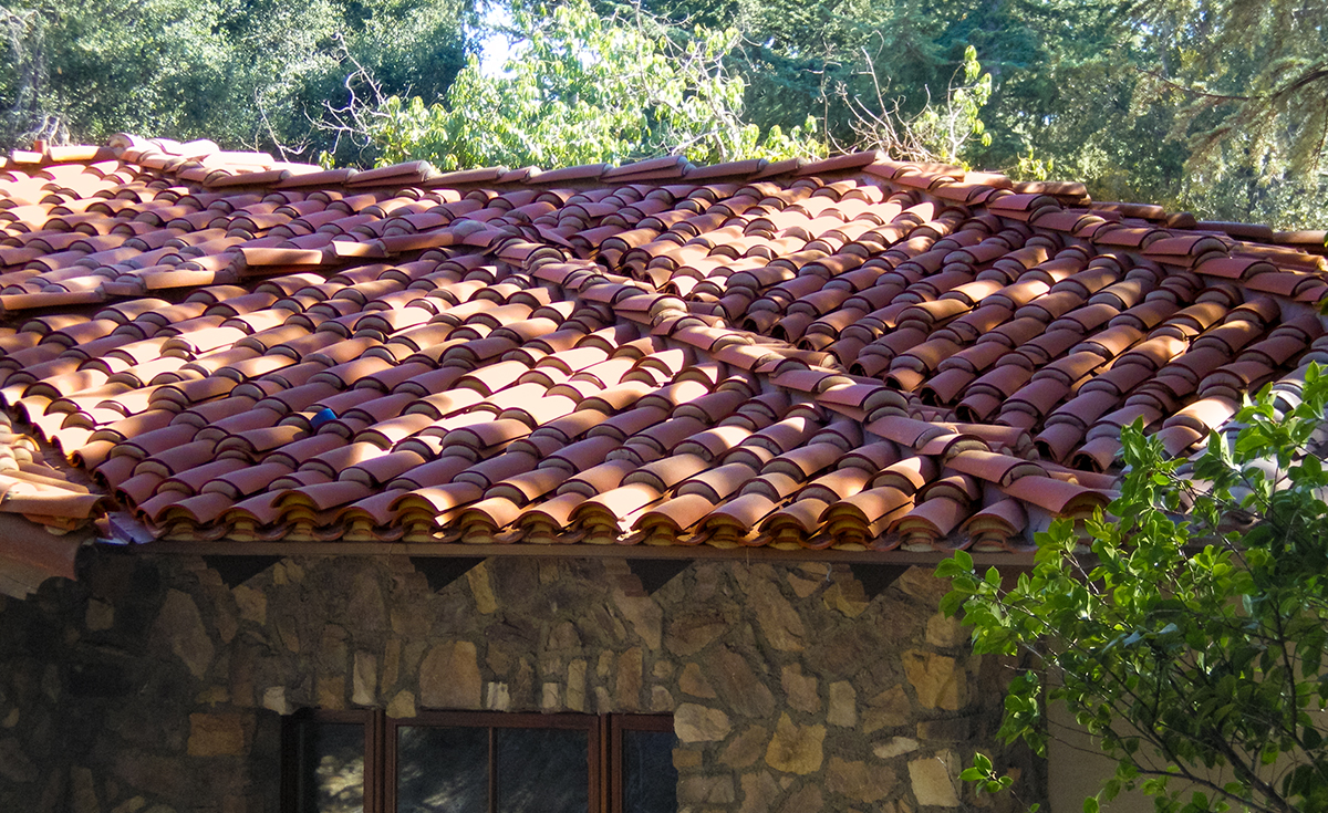 detail of classic tapered mission clay roof two piece tile in 67% F72 Mahogany and 33% F45 tobacco with weepy mortar and field boosting on custom home in La Cañada Flintridge California