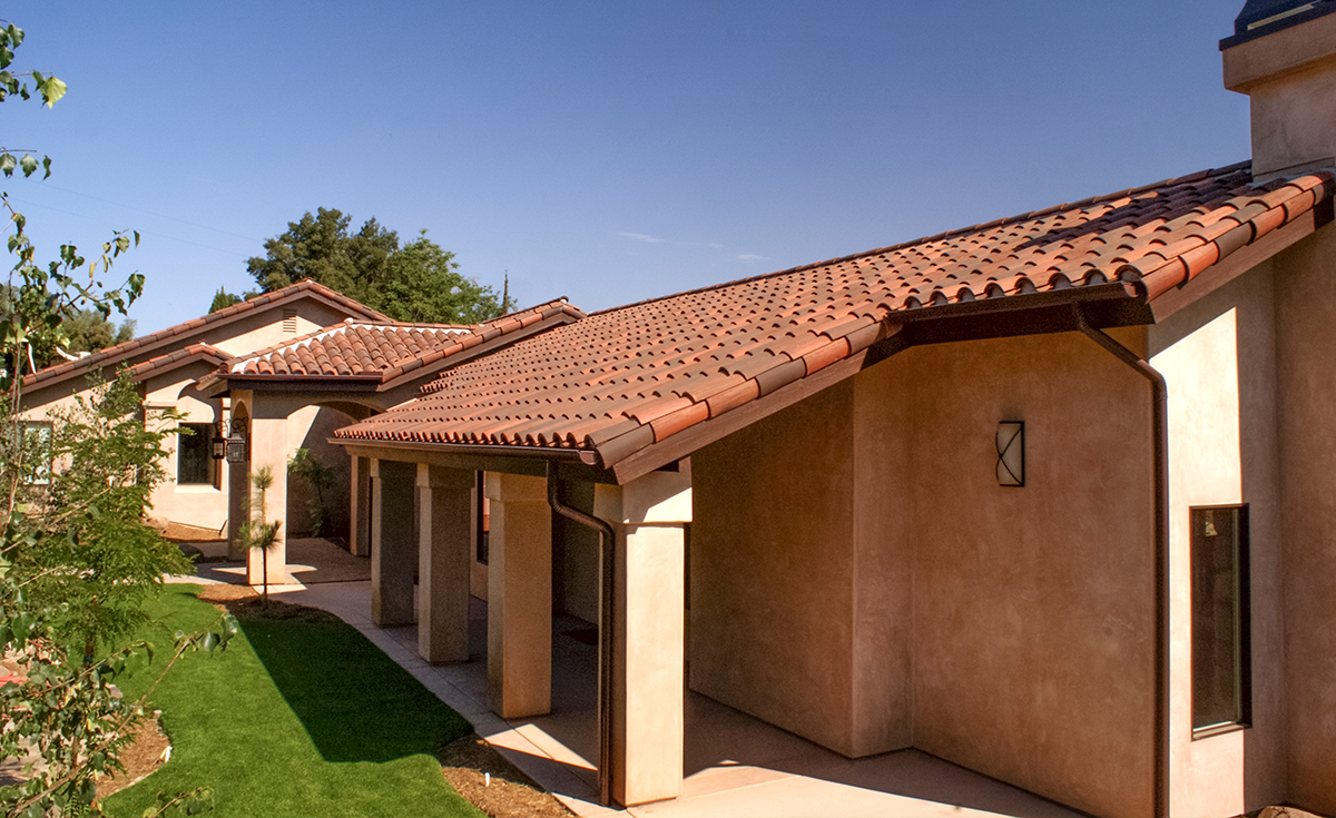 Side view of Classic S mission clay roof tile with 2 piece eave line in 1/3 B330-R Old Santa Barbara Blend, 1/3 2F45-SC Tobacco Sand Cast, and 1/3 2F45CC16D Tierra Brown Dark (Smooth) on custom home in El Cajon, California