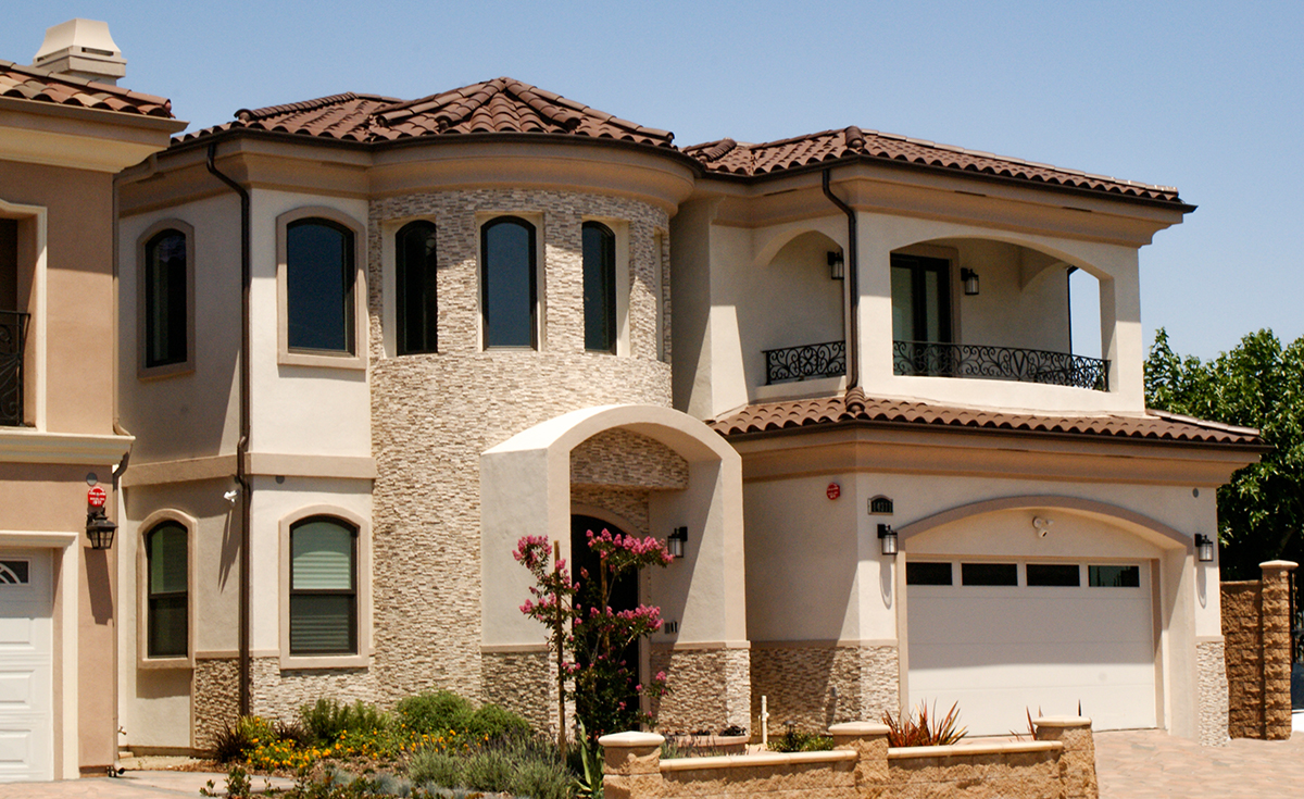 One Piece S Mission clay roof tile in 2F73 Espresso Brown color on Mediterranean style two story custom home in Garden Grove California.