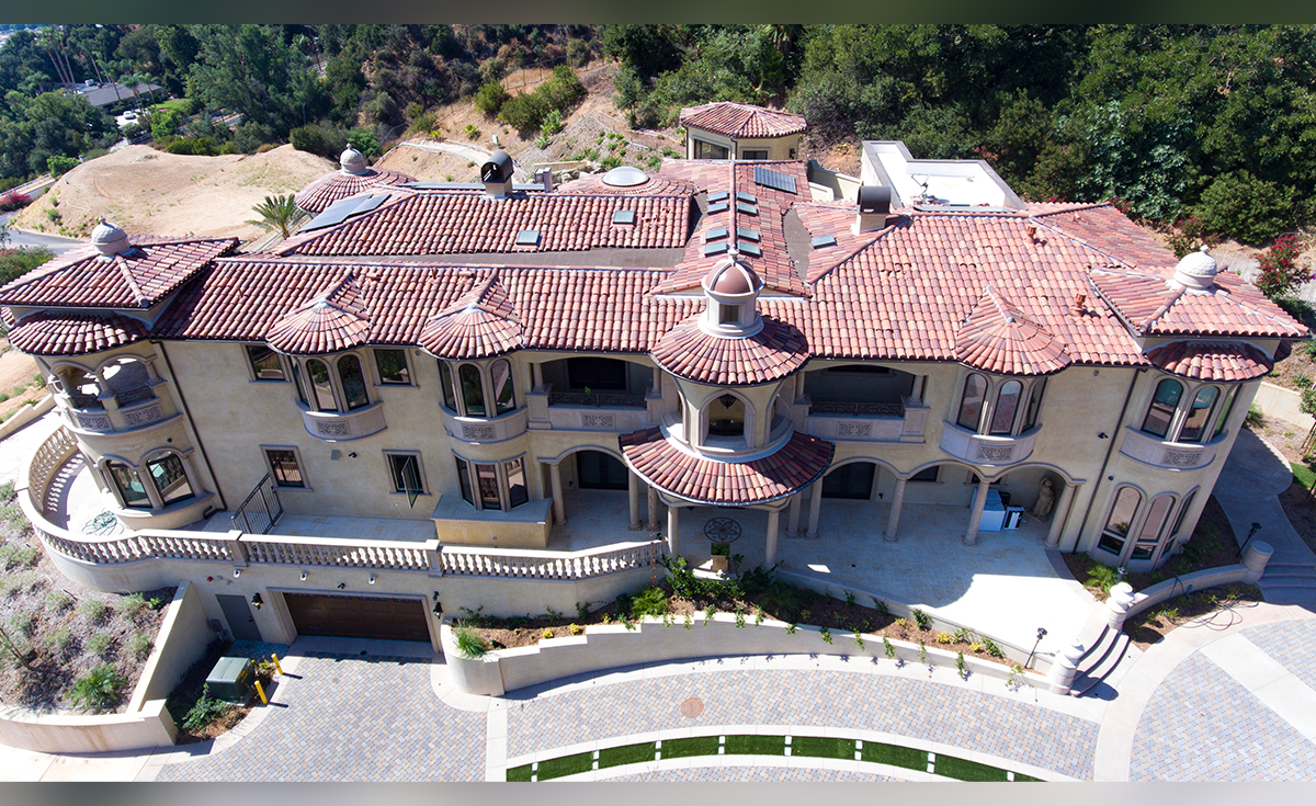 Full overhead view of custom mansion on a hilltop in Bradbury California featuring Classic Tapered two piece terra-cotta clay roof tile with turrets, domes, and dome awnings in custom color blend CB477.