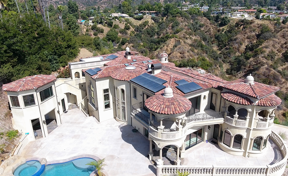 Full overhead view of back of a custom mansion on a hilltop in Bradbury California featuring Classic Tapered two piece terra-cotta clay roof tile with turrets, domes, and dome awnings in custom color blend CB477.