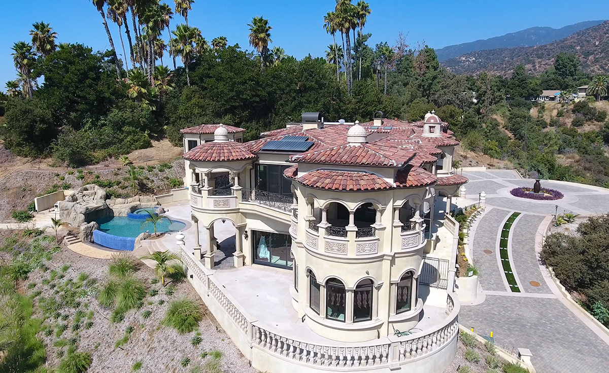 View of dome awnings and roof on custom mansion on a hilltop in Bradbury California featuring Classic Tapered two piece terra-cotta clay roof tile with turrets, domes, and dome awnings in custom color blend CB477.