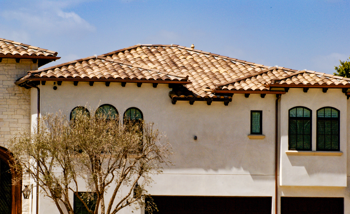 Detail of New home in Yorba Linda California featuring One Piece S Mission terra-cotta Spanish style clay roof tile in B334-R Rustic Ivory Blend