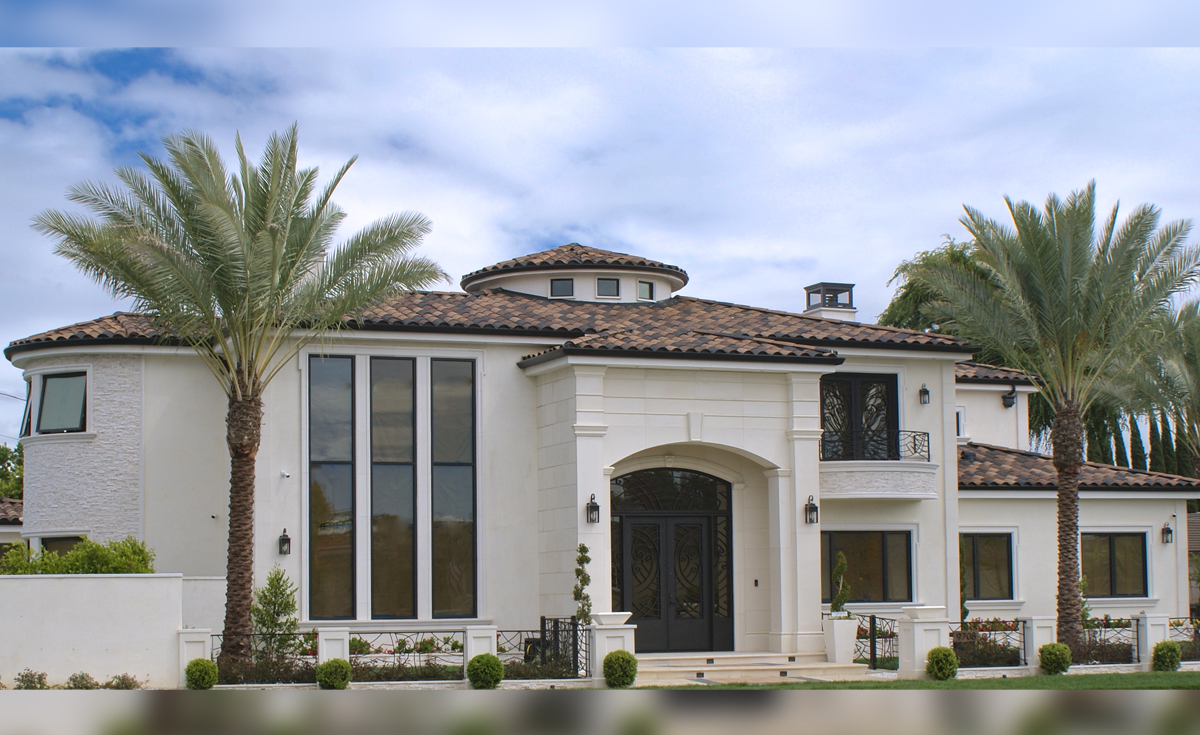 Custom home in Downey, CA featuring One Piece S Mission Spanish style clay roof tile in 80% B317-R Taupe Smoke Blend, 20% 2F51-R Adobe Black Pebbled with 100% 2F51 Adobe Black birdstop