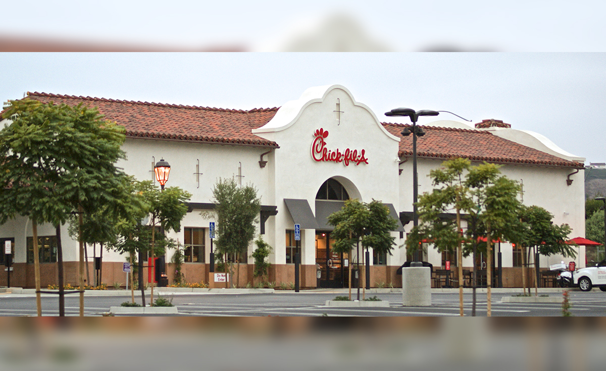 Chick Fil A at Outlets San Clemente, California featuring Corona Tapered Mission Spanish style two piece clay roof tile in 50% CC16L-R Old Santa Barbara Light, 50% CC16M-R Old Santa Barbara Medium with 100% CC16L Old Santa Barbara Light Pans and Birdstop.